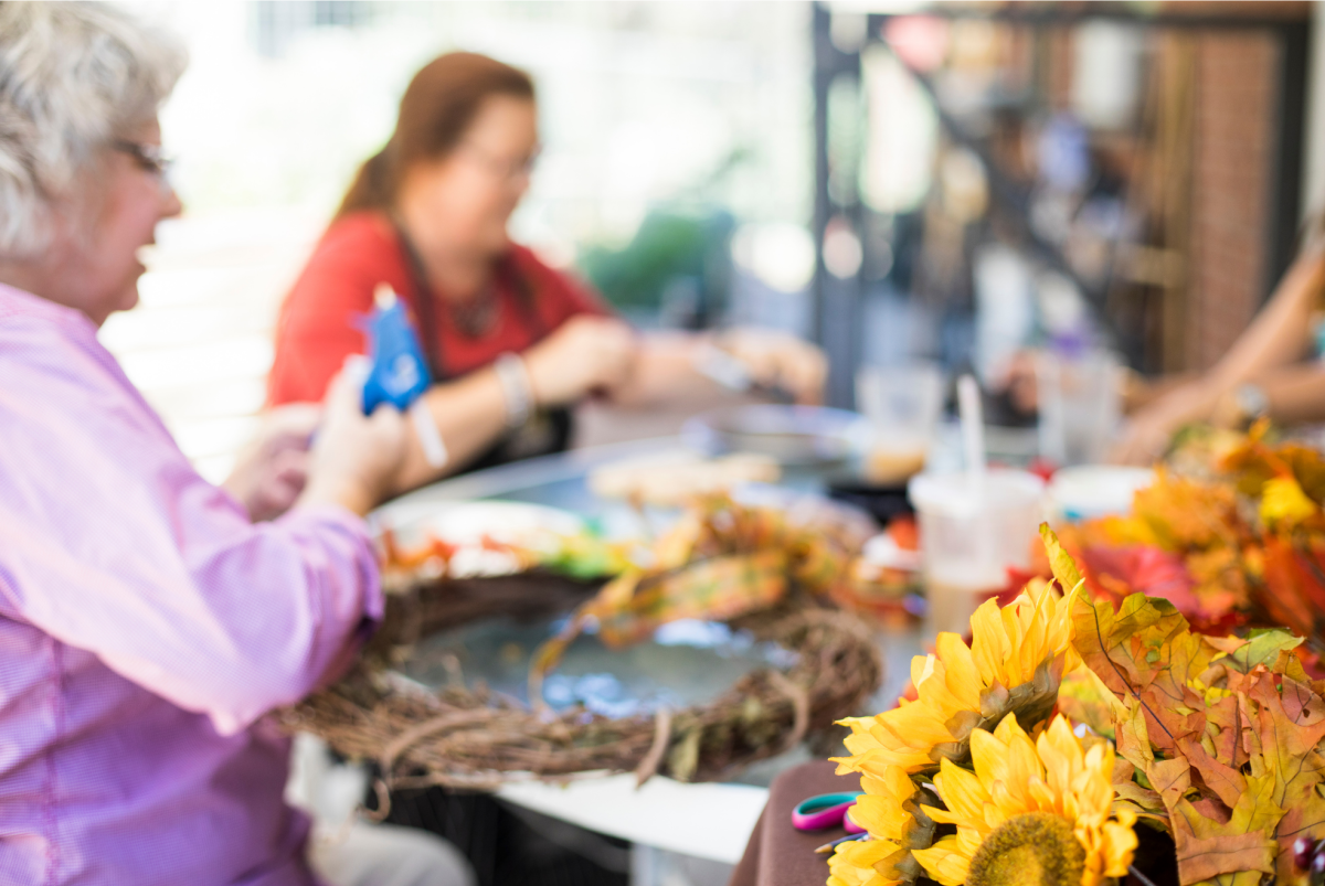 People at a table creating fall wreaths