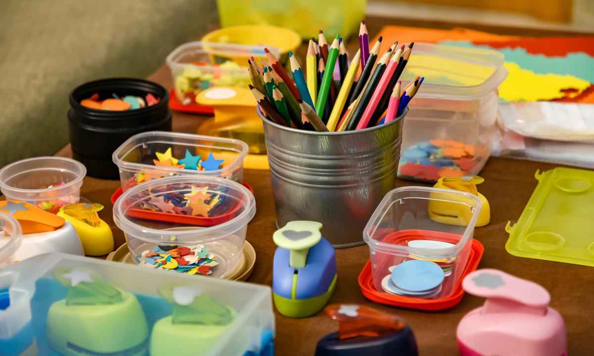 Colored pencils and paper punches on table